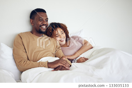 Black couple, bedroom tv watching and bed rest in the morning together with love and care. Happiness, home and smile of a woman and man feeling happy about streaming a movie in a house with bonding Black couple, bedroom tv watching and bed rest in the morning together with love and care. Happiness, home and smile of a woman and man feeling happy about streaming a movie in a house with bonding 133035133