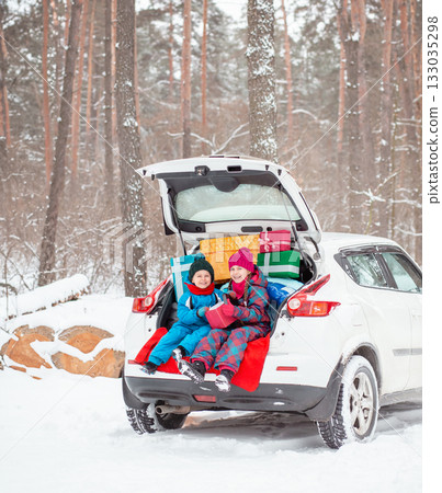 Merry Christmas. Happy New Year. Happy family with children sitting in car Merry Christmas. Happy New Year. Happy family with children sitting in car 133035298