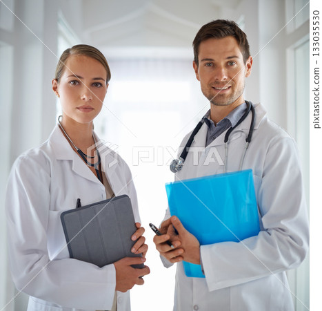 Portrait of doctors, teamwork and hospital for healthcare management, clinic services and professional consulting. Man, woman and medical employees with folder for collaboration, integrity and trust Portrait of doctors, teamwork and hospital for healthcare management, clinic services and professional consulting. Man, woman and medical employees with folder for collaboration, integrity and trust 133035530