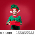 Happy surprise, impression, emotions boy dressed as a Christmas elf holding 133035588