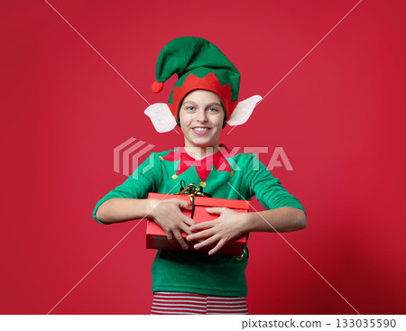 Happy surprise, impression, emotions boy dressed as a Christmas elf holding 133035590