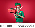 Happy surprise, impression, emotions boy dressed as a Christmas elf holding 133035593