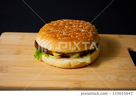Juicy Hamburger with Lettuce and Onion on Board Juicy Hamburger with Lettuce and Onion on Board 133035647