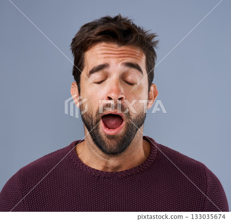 Tired, yawn and man in studio for fatigue or low energy against a grey background. Exhausted, yawning and face of bored male sleepy, lazy or suffering from insomnia, problem or burnout with emoji Tired, yawn and man in studio for fatigue or low energy against a grey background. Exhausted, yawning and face of bored male sleepy, lazy or suffering from insomnia, problem or burnout with emoji 133035674