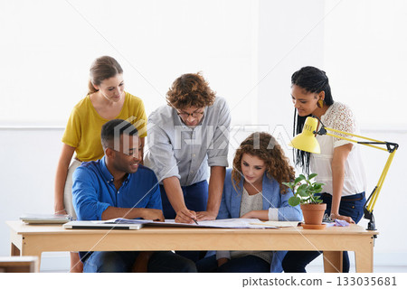 Businessman, coaching and writing on document for planning, team strategy or training staff at office. Business people listening to coach in teamwork for group project, paperwork or plan at workplace Businessman, coaching and writing on document for planning, team strategy or training staff at office. Business people listening to coach in teamwork for group project, paperwork or plan at workplace 133035681