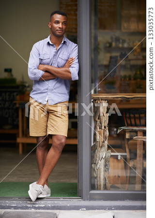 Coffee shop, arms crossed and man as small business owner at door thinking of future ideas. African entrepreneur, manager or restaurant waiter with smile for service, career pride and confidence 133035773