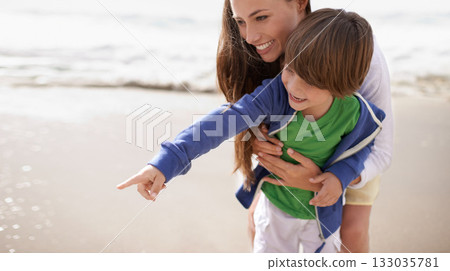 Mother, child and pointing outdoor at beach for family travel or holiday in summer with a smile and fun. A woman and kid or son playing together on vacation at sea with love, care and happiness 133035781