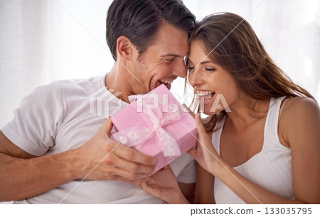 Man giving woman gift, love and happiness with partnership, relationship and celebration on Valentines day date. Couple laugh with present, luxury and commitment, gratitude and celebrate holiday Man giving woman gift, love and happiness with partnership, relationship and celebration on Valentines day date. Couple laugh with present, luxury and commitment, gratitude and celebrate holiday 133035795
