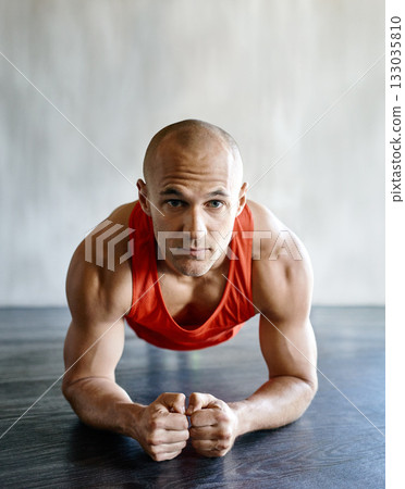 Gym floor, portrait and fitness man focus on plank exercise, health motivation or core strength building for bodybuilding. Training, hard work commitment and person doing muscle development workout 133035810