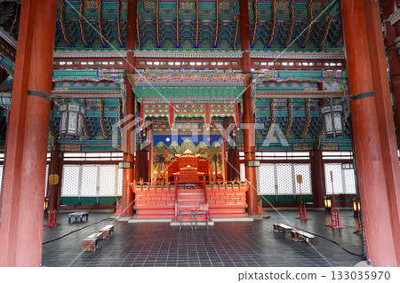 Intricately Painted Wooden Pillars and Vibrant Dancheong Ceilings in the Historic Interior of a Traditional Korean Palace Intricately Painted Wooden Pillars and Vibrant Dancheong Ceilings in the Historic Interior of a Traditional Korean Palace 133035970