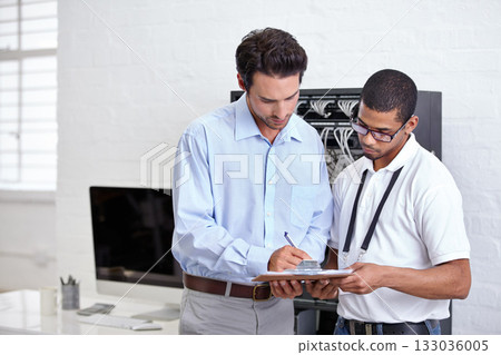 Server room, contract and a business man signing a deal with a technician for cyber security. Network, database or documents with a male employee making an agreement with an it support engineer Server room, contract and a business man signing a deal with a technician for cyber security. Network, database or documents with a male employee making an agreement with an it support engineer 133036005