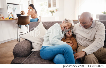 Laughing, happy and grandparents babysitting a child, bonding and being funny on the sofa. Smile, comic and boy kid speaking to a senior man and woman on the living room couch for quality time 133036078