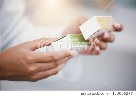 Pharmacist woman, medicine in hands and pills, healthcare and prescription medication in drug store. Medical, closeup and pharmaceutical product box for health, wellness and treatment with pharmacy 133036277