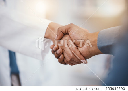 Doctor, patient and handshake in hospital thank you, welcome or greeting for medicine trust, help or medical consulting. Zoom, black man and shaking hands with pharmacy worker or healthcare employee 133036290