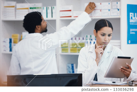 Thinking pharmacist, woman and tablet in medicine check, stock take or medical research in drugs store. Serious, ideas and pharmacy worker on technology pills, checklist or ecommerce healthcare order 133036298