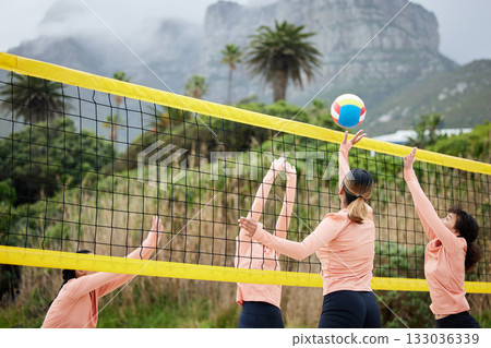 Volleyball, beach and team with sports women playing a game outdoor for training or competition. Summer, sport and ball with female friends on the sand by the coast to play a competitive match 133036339