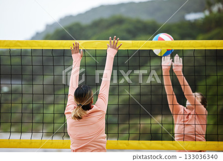 Volleyball, beach and training with sports women playing a game outdoor for competition in summer. Team, sport and ball with female friends on the sand by the coast to play a competitive match 133036340