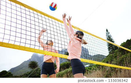 Volleyball, beach and spike with sports women playing a game outdoor for training or competition. Team, sport and ball with female friends on the sand by the coast to play a competitive match 133036342