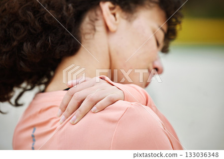 Shoulder pain, fitness and woman with injury at beach after volleyball accident, workout or training. Health, sports or female with fibromyalgia, inflammation or painful back, arthritis or tendinitis 133036348