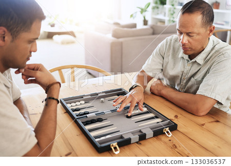 Man, senior and play backgammon in house with focus, strategy and contest for thinking, moving or son by table. Elderly man, board game competition and relax with bonding, love and family home lounge 133036537