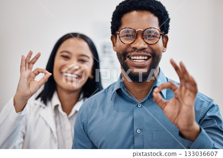 Perfect, optometry and portrait of a black man and optician with glasses, eyecare and choice of eyewear. Okay, happy and patient with a decision on eyeglasses with an optometrist and hand gesture 133036607