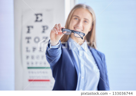Optometry, vision and portrait of a woman with glasses with prescription lens after a eye test. Healthcare, eyewear and female patient or customer holding spectacles frame for sight in optical store. Optometry, vision and portrait of a woman with glasses with prescription lens after a eye test. Healthcare, eyewear and female patient or customer holding spectacles frame for sight in optical store. 133036744