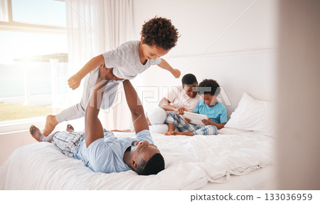 Playing, holding and father with a child on the bed for bonding, quality time and fun in the morning. Family, happy and African dad being playful, carefree and loving with a boy kid in the bedroom 133036959