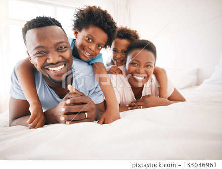 Happy, bonding and portrait of a black family on a bed for playing, quality time and comfort. Smile, love and African children with parents in the bedroom for happiness, relaxation and stress relief Happy, bonding and portrait of a black family on a bed for playing, quality time and comfort. Smile, love and African children with parents in the bedroom for happiness, relaxation and stress relief 133036961