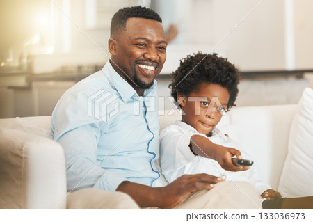 Black family, sofa and father with boy with remote for tv channel, streaming movies and watching film. Love, home and happy dad with child with television control for entertainment, cartoon and relax 133036973