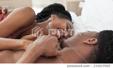 Happy, black couple and wake up in bedroom in the morning for love, romance and intimacy at house or home. Young, man and woman with smile and bonding together or relax on a weekend with quality time Happy, black couple and wake up in bedroom in the morning for love, romance and intimacy at house or home. Young, man and woman with smile and bonding together or relax on a weekend with quality time 133037005