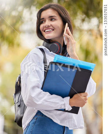 Student, woman and phone call at campus, outdoor and smile for conversation, chat and excited in summer. Young gen z girl, smartphone communication and networking at university with books in sunshine 133037031
