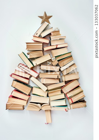 Creative Christmas tree made from books with star topper for holiday decoration. Happy New Year. Vertical banner. Copy space. World book day. Back to school 133037062