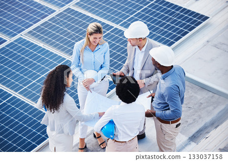 Solar and renewable energy, blueprint or engineering team on roof building electricity technology for sustainability. Collaboration, top view or black man talking or planning a project with people Solar and renewable energy, blueprint or engineering team on roof building electricity technology for sustainability. Collaboration, top view or black man talking or planning a project with people 133037158