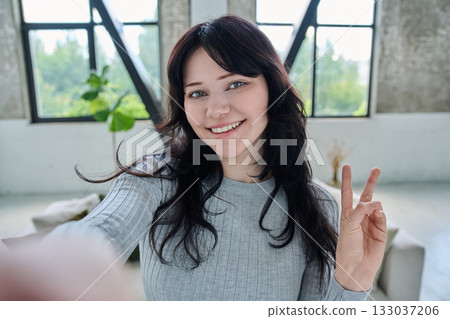 Selfie portrait happy beautiful young woman in home interior Selfie portrait happy beautiful young woman in home interior 133037206