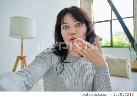 Selfie portrait happy beautiful young woman in home interior 133037218