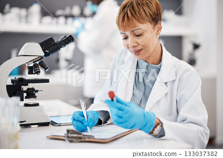 Scientist, woman and writing report with results, focus or analytics in pharma laboratory. Science expert, checklist or research with blood sample, medical innovation or study at pharmaceutical trial 133037382