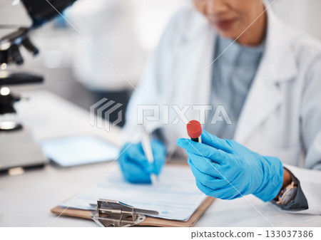 Scientist, woman and writing lab results with study, focus or analysis for pharma development. Science expert, checklist and documents with microscope, innovation and report of pharmaceutical trial 133037386