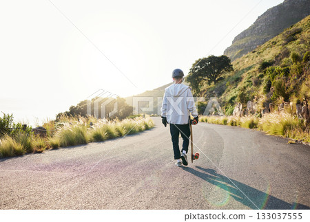 Skateboard, road walking and athlete doing training, exercise and fitness on a hill. Sun, man back and summer sport of a young person ready for balance and freedom from extreme sports with mockup 133037555