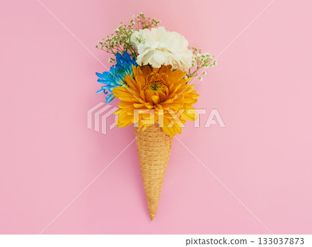 Flowers, cone and ice cream in a studio for decoration, creativity or art with fresh and colorful bouquet. Creative, still life and blossom floral plants in a dessert isolated by pink background. 133037873