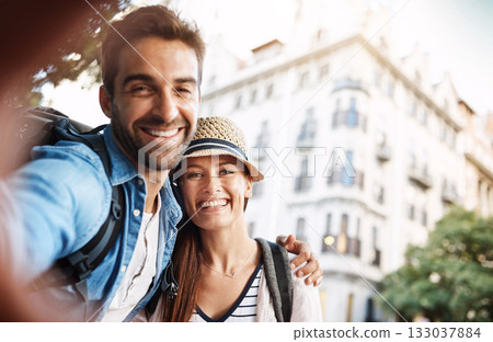 Selfie, tourist couple and outdoor in a city for travel on a street with a happy smile. Man and woman together for summer holiday memory on urban road for adventure, journey and vacation or freedom Selfie, tourist couple and outdoor in a city for travel on a street with a happy smile. Man and woman together for summer holiday memory on urban road for adventure, journey and vacation or freedom 133037884
