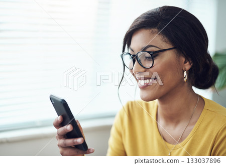 Phone, typing and happy woman reading online, social media post or networking on internet for job search. Creative, communication and african person in glasses, texting on mobile app or chat at home 133037896