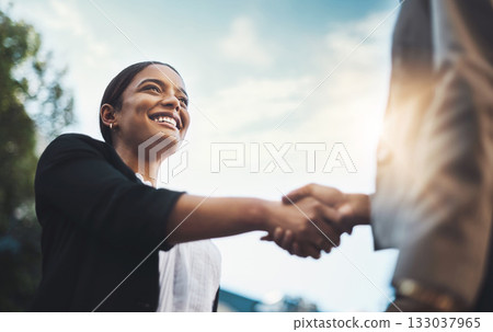 Business people, handshake and meeting in city for partnership, greeting or introduction and welcome outdoors. Happy woman with smile shaking hands for b2b, collaboration or agreement in deal outside 133037965