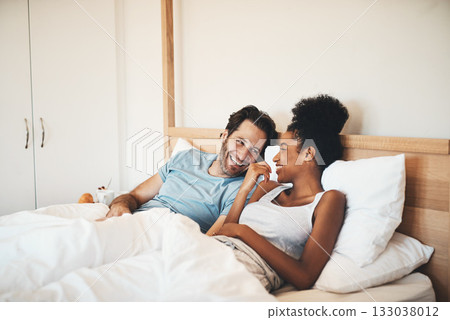 Interracial couple, laughing and relax on bed for morning bonding, funny relationship or joke at home. Happy woman and man with smile, laugh and lying in bedroom for fun talk or conversation indoors Interracial couple, laughing and relax on bed for morning bonding, funny relationship or joke at home. Happy woman and man with smile, laugh and lying in bedroom for fun talk or conversation indoors 133038012