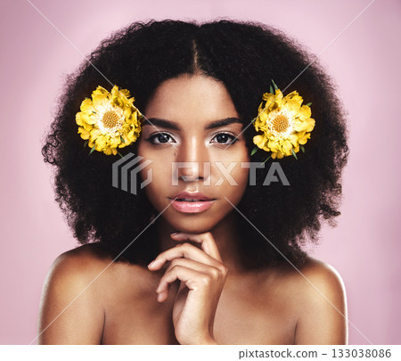 Face, serious woman and flowers for hair care in studio, pink background and beauty of floral aesthetic. Portrait of african model, natural skincare and yellow plants in afro of sustainable cosmetics Face, serious woman and flowers for hair care in studio, pink background and beauty of floral aesthetic. Portrait of african model, natural skincare and yellow plants in afro of sustainable cosmetics 133038086