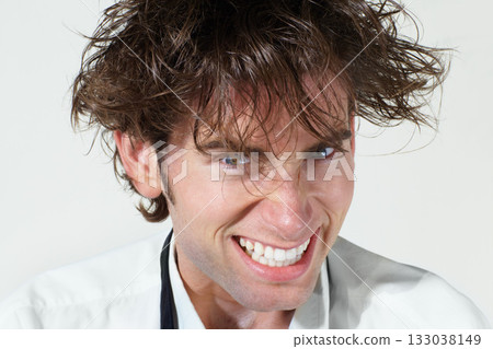 Crazy, portrait and mad scientist man on white background with stress, mistake and insane hair. Mental health, psychosis and face of funny male person for chemistry, experiment and failed research Crazy, portrait and mad scientist man on white background with stress, mistake and insane hair. Mental health, psychosis and face of funny male person for chemistry, experiment and failed research 133038149