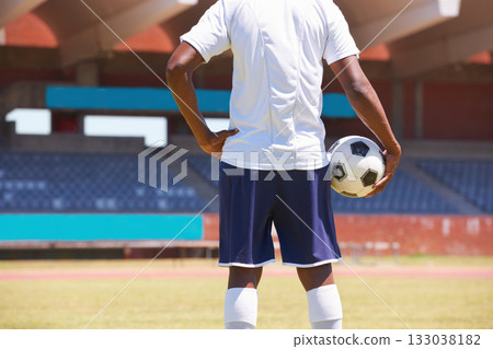 Man, holding soccer ball and back in stadium for game, competition or outdoor for sports career. Football player, ready and motivation for sport, workout and exercise for health, wellness and contest 133038182