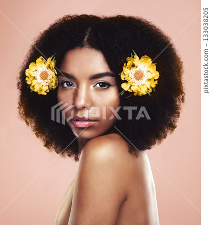 Face of serious woman, flowers and hair in studio background for beauty, eco friendly aesthetic and glow. Portrait of african model, natural skincare and floral plants in afro for sustainable makeup 133038205