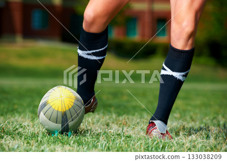 Rugby, feet and man with a sports ball outdoor on a pitch for action, goal or score. Male athlete person playing in sport competition, game or start training for fitness, workout or kick exercise 133038209