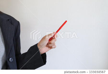 Businesswoman holding a red pen 133038567
