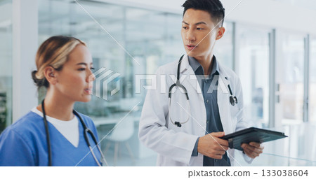 Tablet, consulting and teamwork with doctors in hospital for results, digital chart and medicine. Healthcare, medical and research with people walking in clinic for surgery, wellness and feedback Tablet, consulting and teamwork with doctors in hospital for results, digital chart and medicine. Healthcare, medical and research with people walking in clinic for surgery, wellness and feedback 133038604